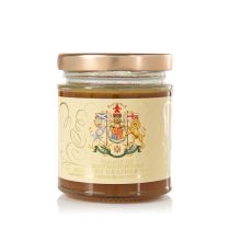 Glass jar of honey with gold lid. The jar is wrapped with a label displaying the Scottish Coat of Arms.