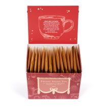 Open festive spiced tea with 15 gold tea envelopes, red packaging and gold detailing, as well as instructions of how to best serve. 