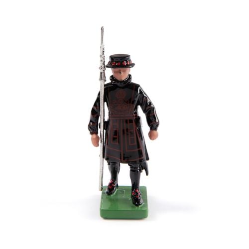 Small Yeoman Warder figurine with black outfit and green base. 