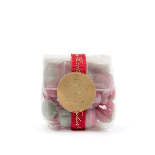 A transparent bag of Rosey Apple sweets in pink and green with red Windsor Castle ribbon and circular gold label