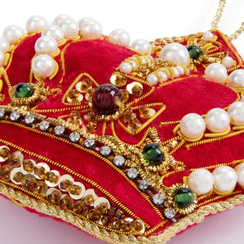 Red crown decorations with pearl studs and red gems. 