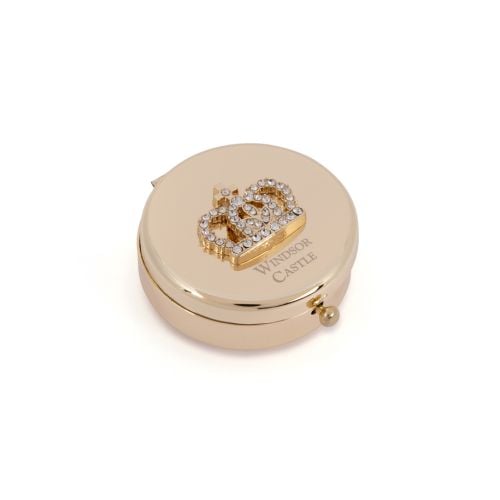 Gold compact mirror with bejewelled crown on top. Windsor Castle etched below.