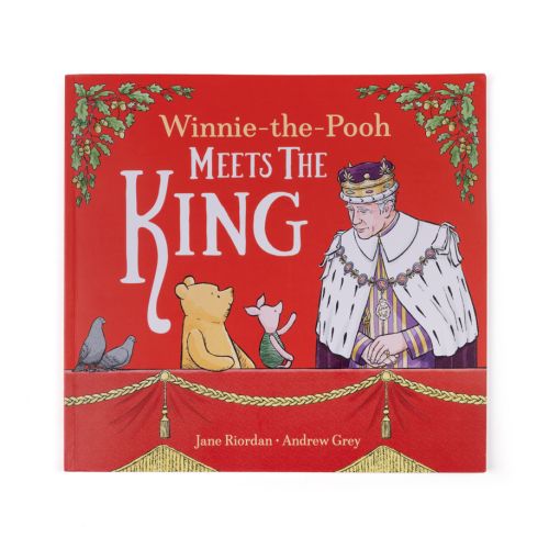 Red childrens book with Winnie-the-Pooh Meets The King" as main title featuring an illustrtaion of Winnie-The-Pooh, Piglet and His Majest the King. 