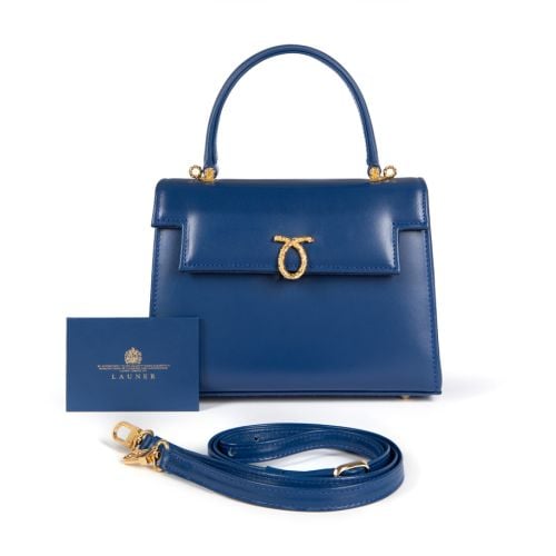 A blue leather handbag with top handle and gold coloured clasp