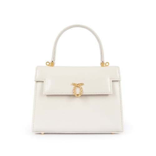 A cream leather handbag with top handle and gold coloured clasp