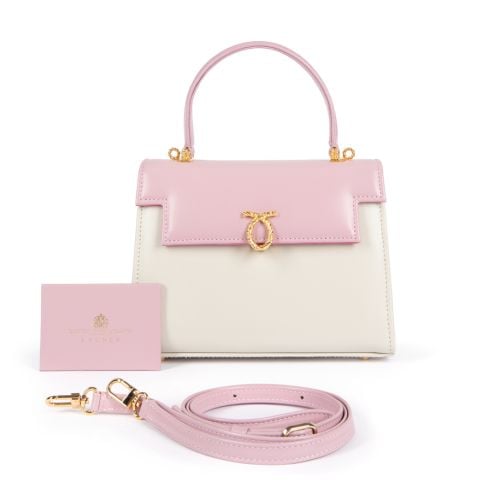 A pink and cream leather handbag with top handle and gold coloured clasp