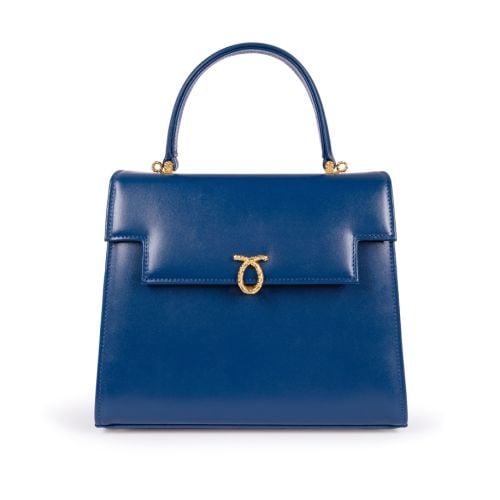 A dark blue leather handbag with top handle and gold coloured clasp