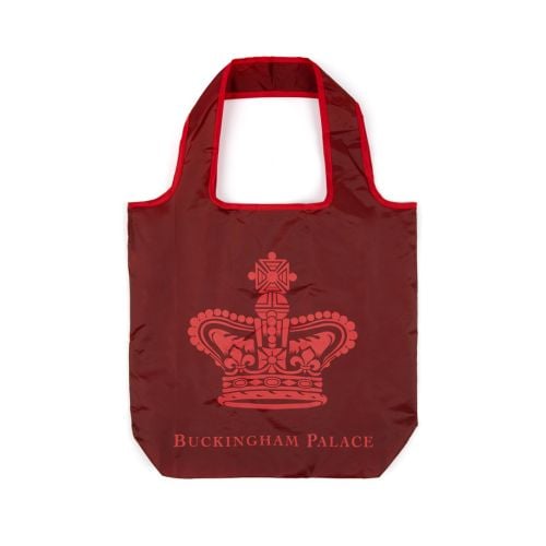 A red bag with handle and crown motif with Buckingham Palace below it