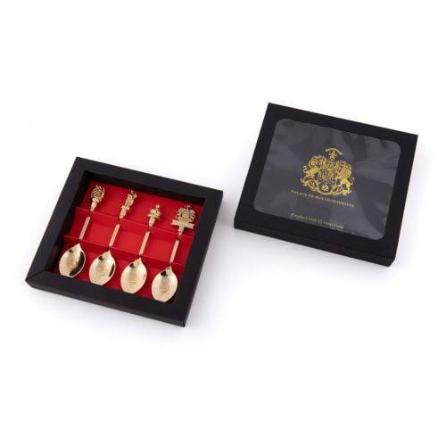 The Palace of Holyroodhouse gold tea spoon set with Scottish figures including a a Scottish piper, royal corwn, in black packaging. 