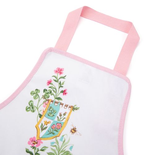 The Children's Unicorn Apron, featuring the new designs with unicorns in a wild meadow against a white backdrop. The illustration features unicorns amongst wildflowers with flags and woodland creatures.  The front pocket features a white and red strip wit