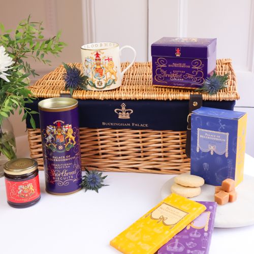 Wicker hamper with various foodhall products, including Shortbread, breakfast tea, strawberry preserve, fudge and chocolate bars. 