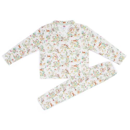 Front of unicorn button down pyjamas with floral forest scene featuring unicorns, crowns, rabbits and flags. 