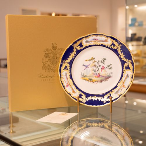 Image of the Prestige Sevres Cobalt Plate on stand, featuring three exotic birds at centre and cobalt blue edging with detailing. 