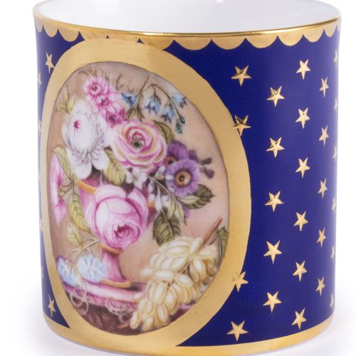 The Prestige Basket of Flowers Gobelet Litron, featuring central oval shape with hand painted bouquet of pink, purple and white flowers in a vase. The rest of the teacup and saucer has a rich cobalt blue paint and is finished with 22 carat gold gilding al