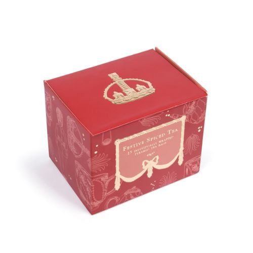 Open festive spiced tea with 15 gold tea envelopes, red packaging and gold detailing, as well as instructions of how to best serve. 