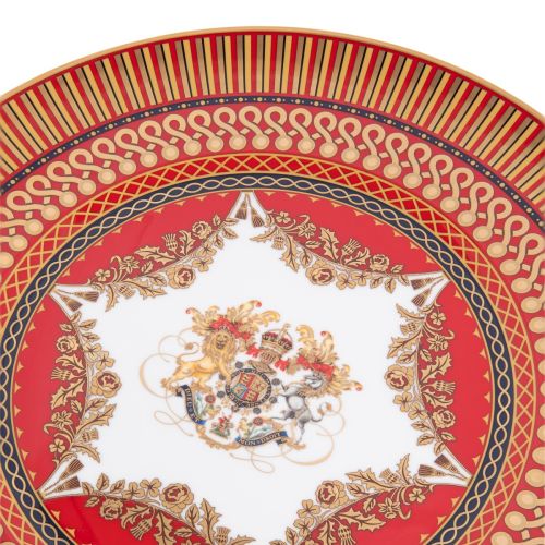 The Livery Limited Edition plate, featuring the royal coat of arms with a deep, rich scarlet design and navy border with contrasting fine gold details, inspired by the intricate decorative braiding of hand-sewn livery.