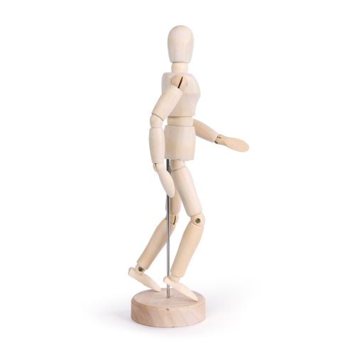 A standing wooden mannequin on pisitioned with a metal pole on a round wooden base. 