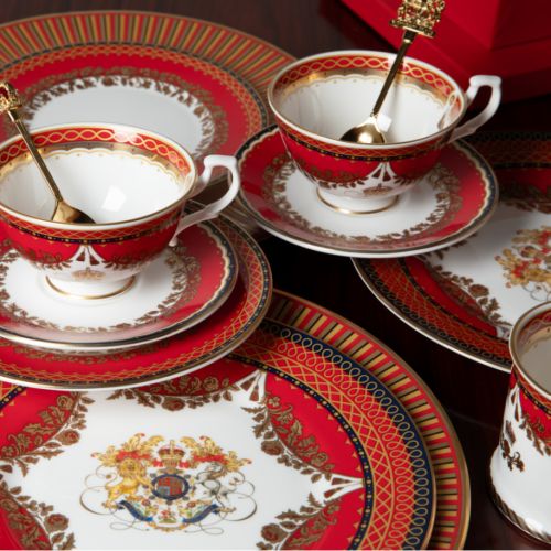 The Livery 8" Dessert Plate featuring the Royal crest at its centre and ornate  and a deep, rich scarlett edge and navy border with contrasting fine gold details, inspired by the intricate decorative braiding of hand-sewn livery and regimental devices of 