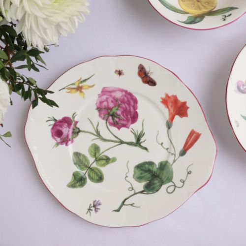 Chelsea Porcelain Salad plate on a table with flowers and other plates from the range. 