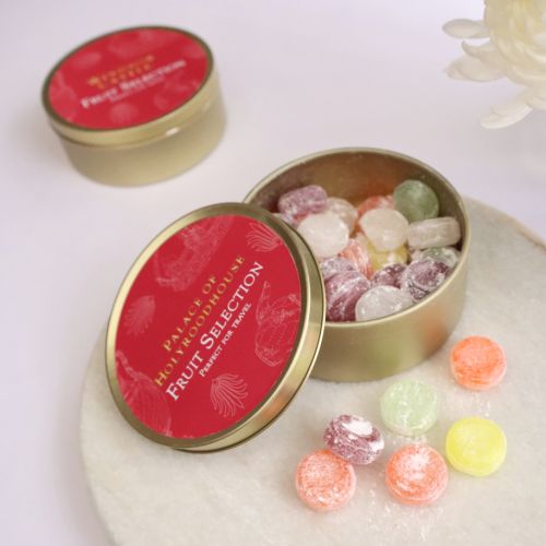 Open gold tin of fruit sweets