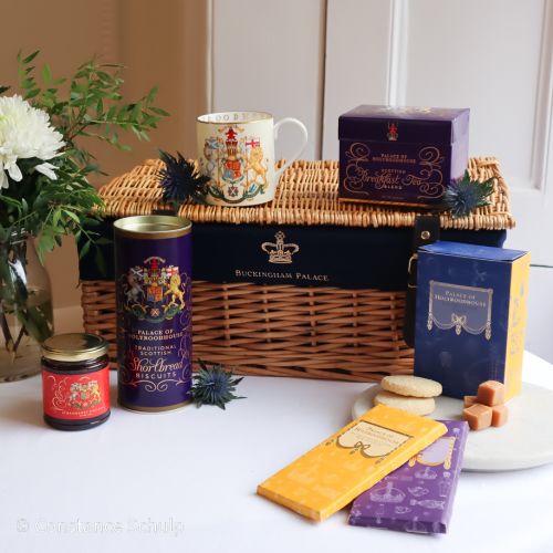 Wicker hamper with various foodhall products, including Shortbread, breakfast tea, strawberry preserve, fudge and chocolate bars. 