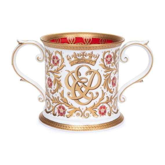 The limited edition 70th anniversary Loving Cup which features golden scrolls and the entwined monogram of The Queen and The Duke of Edinburgh, with red interior, inspired by the elaborate gilded carvings of the thrones in the Throne Room at Buckingham Pa