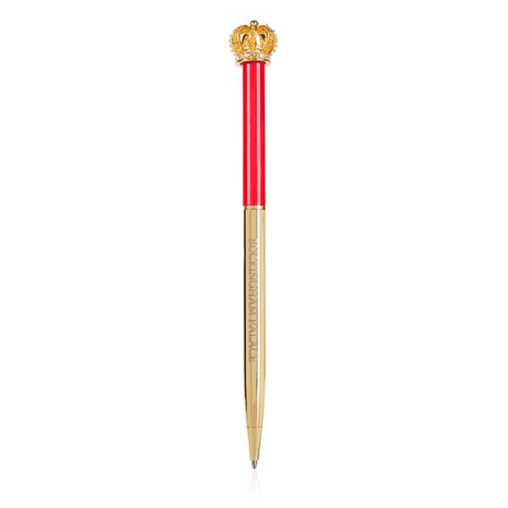 Buckingham Palace pen. Topped with a gold coloured crown. The bottom half of the ballpoint pen is gold and the top half is red