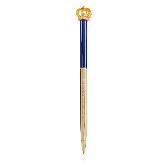 Buckingham Palace pen. Topped with a gold coloured crown. The bottom half of the ballpoint pen is gold and the top half is blue