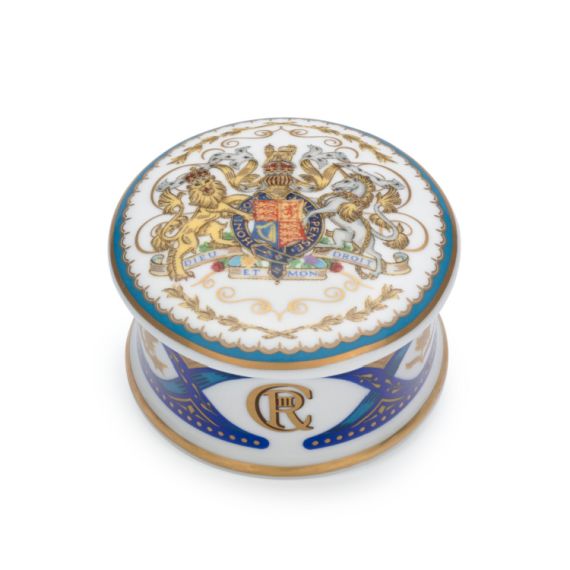 Pillbox featuring the Royal coat of arms on a white lid. Blue and gold decoration adorn the base.