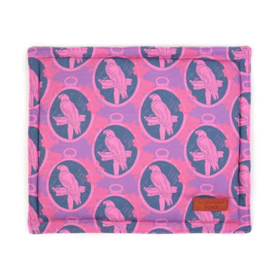 Square pet cushion printed with purple parrot printed material with a leather tag saying Buckingham Palace