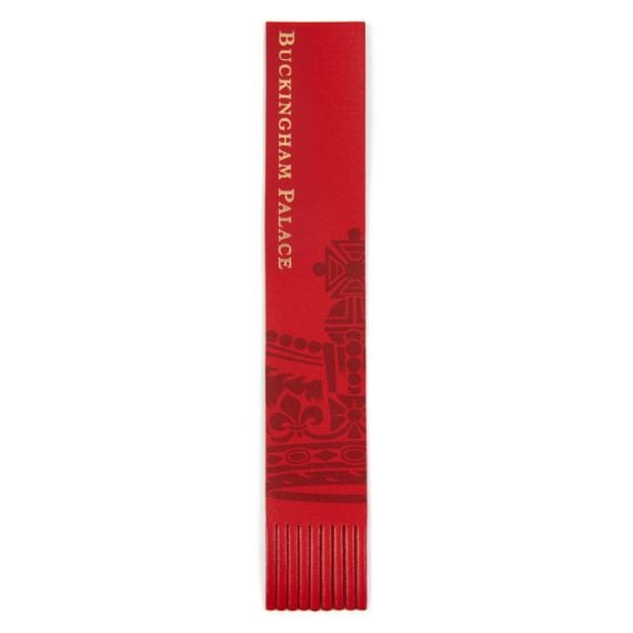 red bookmark with Buckingham Palace in gold foil and a crown illustration.