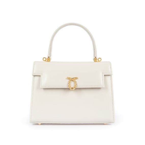 A cream leather handbag with top handle and gold coloured clasp