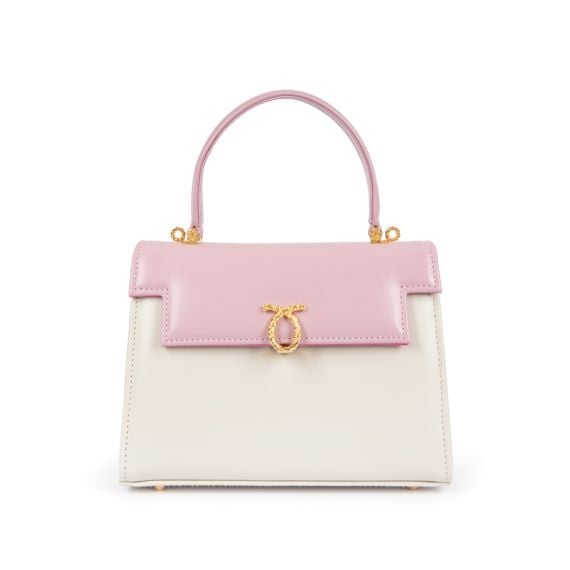 A pink and cream leather handbag with top handle and gold coloured clasp