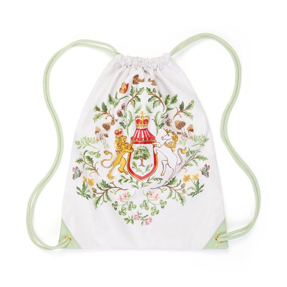 A drawstring bag featuring pastel green cord straps and with illsuatrion featuring the Royal Coat of Arms, surrounded with British wildflowers foliage, and garden wildlife such as birds, bees, and butterflies. 