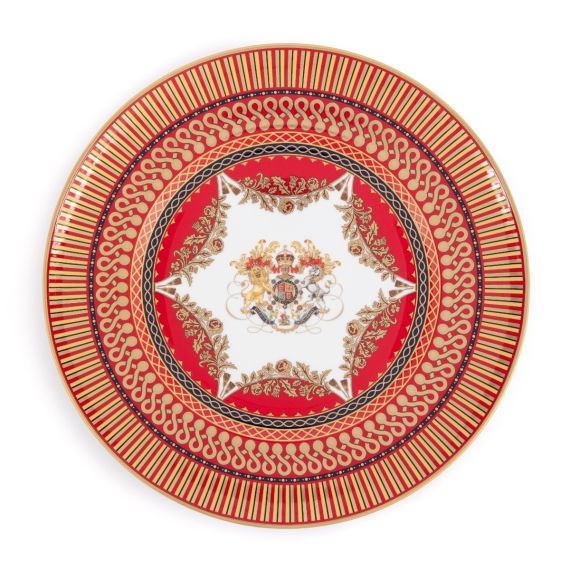 The Livery Limited Edition plate, featuring the royal coat of arms with a deep, rich scarlet design and navy border with contrasting fine gold details, inspired by the intricate decorative braiding of hand-sewn livery.