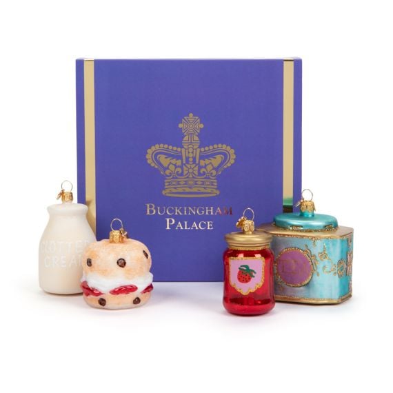 Buckingham Palace Baubles including a blue sleeved box, glass milk, scone, jam and tea caddy ornaments. 