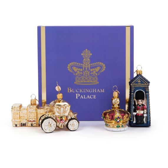 Blue sleeved box with Buckingham Palace glass baubles with Buckingham Palace facacde, golden carriage, crown and guardsman in sentry box. 