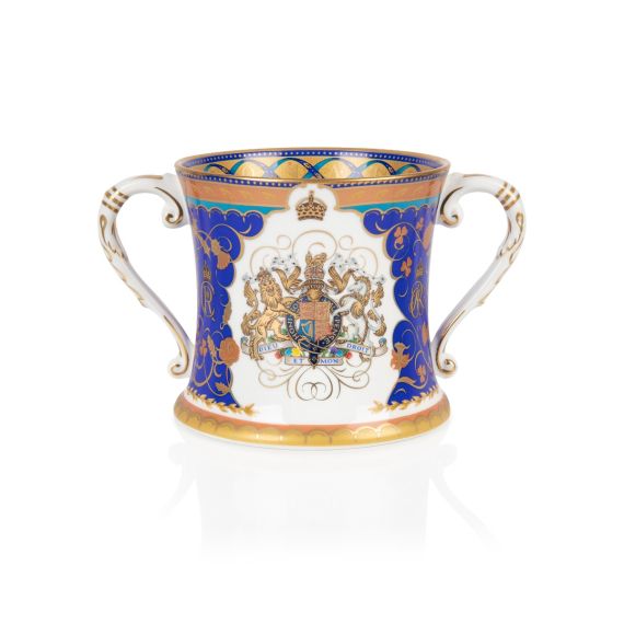 Fine bone china loving cup with blue and gold design, coat of arms at the centre on a white background. Gold band and blue ribbon inside the lip of the cup