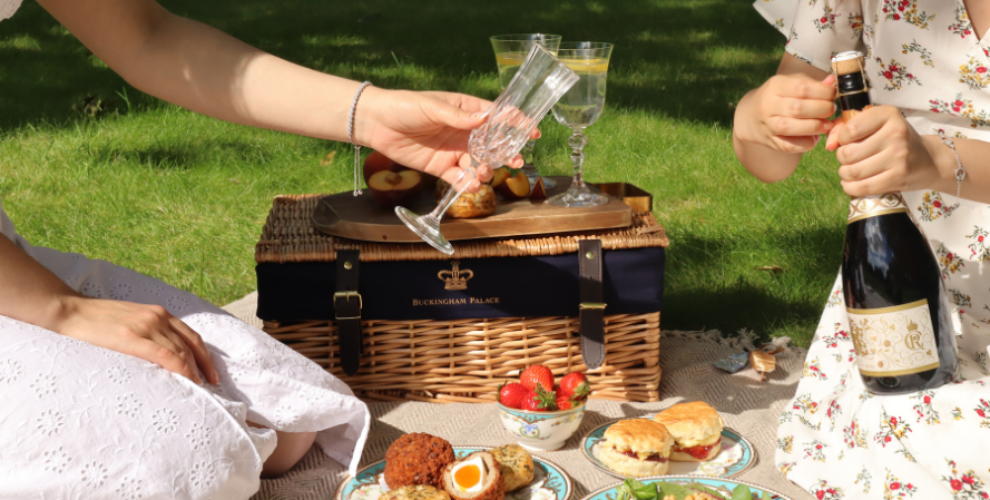 Two people enjoying a picnic with English Sparkling Wine and a variety of picnic food
