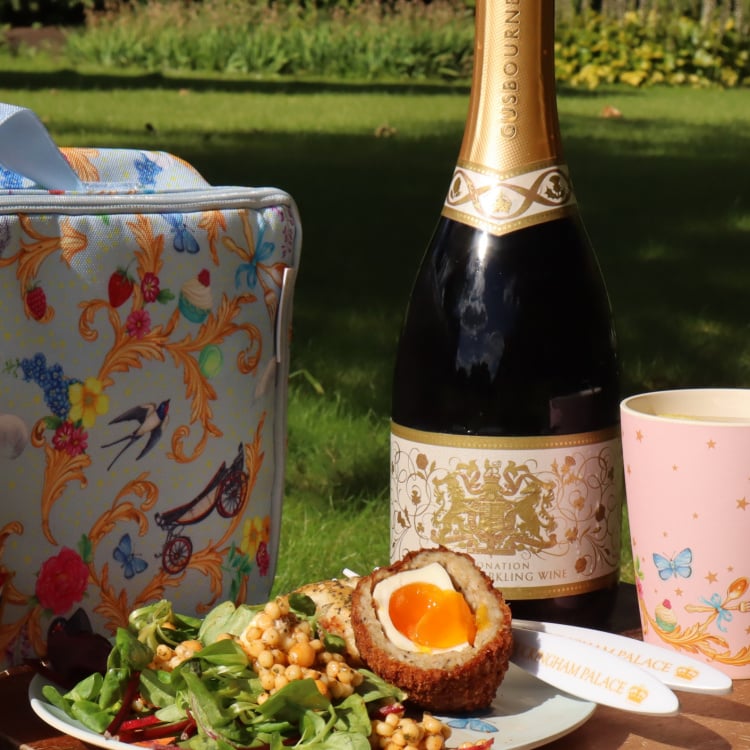 A picnic setup with English Sparkling Wine, a Scotch Egg and salad
